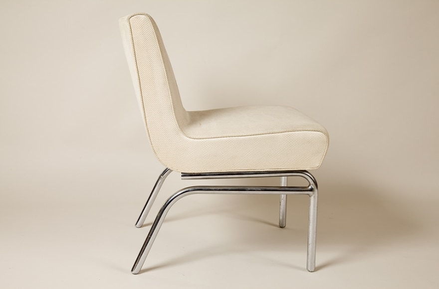 photograph of a white chair in an empty room