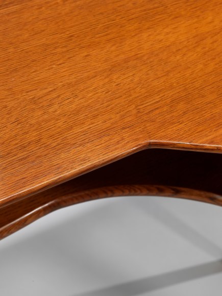 Wooden desk with a mirror in front a white background