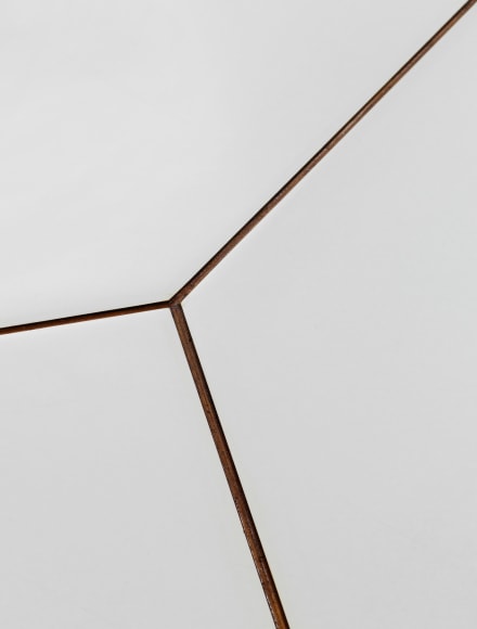 Detail view of how white formica table pieces interact on table top