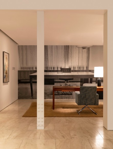 Installation view of Motte's Luge Chair, 1966 and Desk, 1965 with archival image wall vinyl behind. Photo by Ori Harpaz