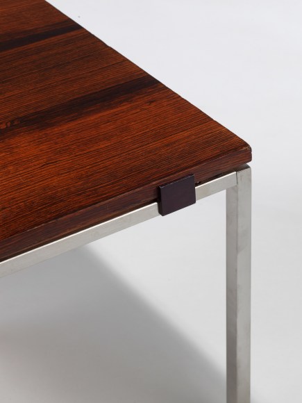 Wooden coffee table with marquetry and chrome metal legs in front of white background