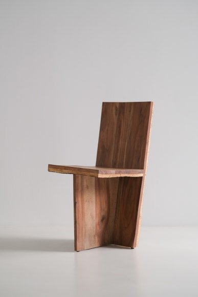 wood and cork chair with angled back shown in every angle against a grey background.