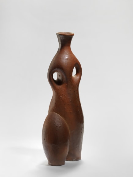 photograph of an anthropomorphic vase in an empty room