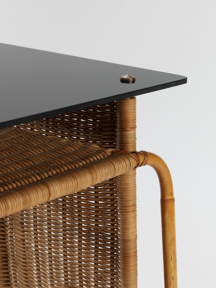 rattan desk in an empty room