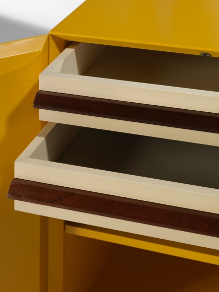 photograph of a yellow cabinet in a blank room