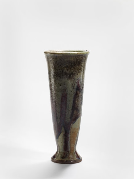 photograph of a ceramic vase in an empty room