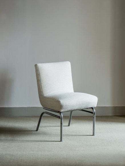 photograph of a white chair in an empty room