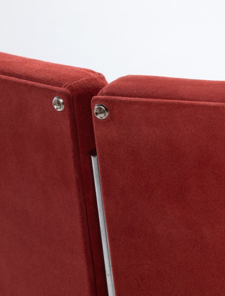 Single chair in red suede made by Pierre Guariche detail shot of back.