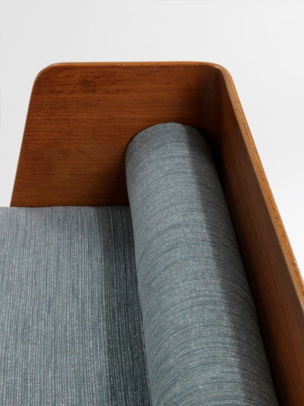 wood daybed in an empty room