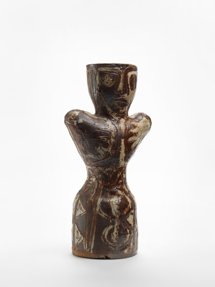 photograph of an anthropomorphic object in an empty room