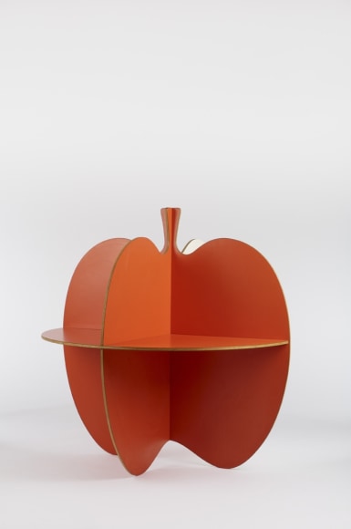 picture of a table that is shaped like an apple in an empty room