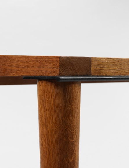 photograph of wood dining table in a blank room