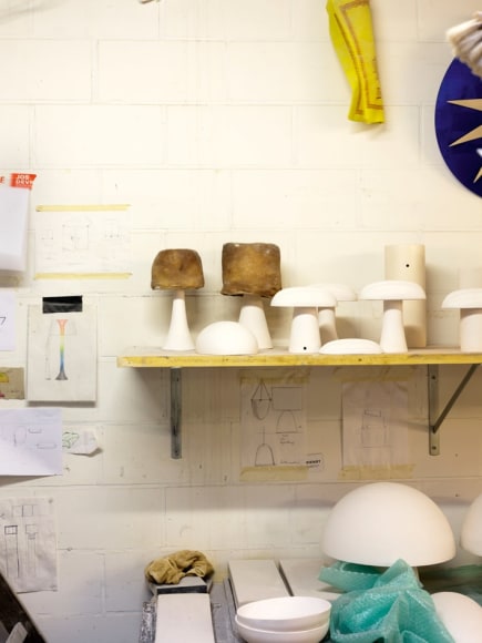 Lamps in progress amid Devriendt&rsquo;s sketches on his studio wall.&nbsp;