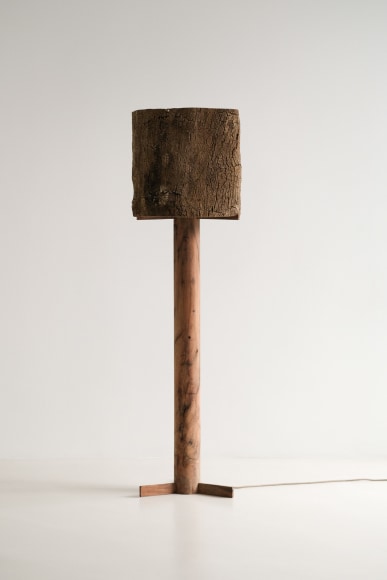 Cork and Oak floor lamp against an empty room turned off.