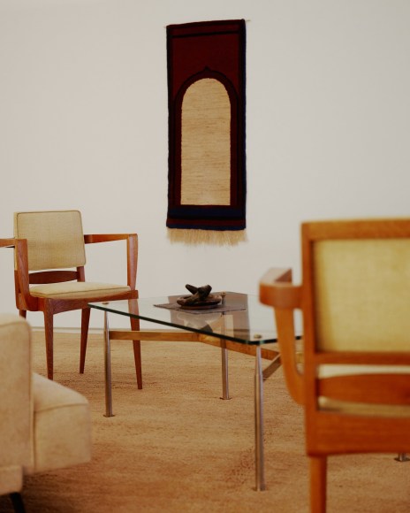 Installation view of works in the gallery, mostly furniture and some rugs and art. Sheila Hicks work in background.