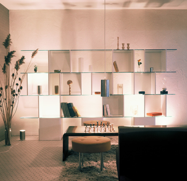 Archival photo of a modular bookcase, coffee table, ottoman, and metal light pendant at Charron, 1965