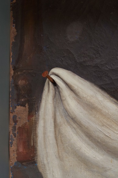 Robert Gober art work of a girl hanging upside down and reading with a branch and aluminum frame.