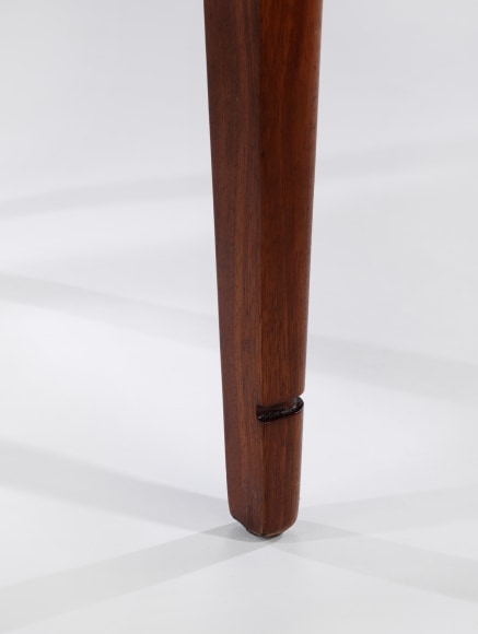 Close up of wooden chair leg with notched detail