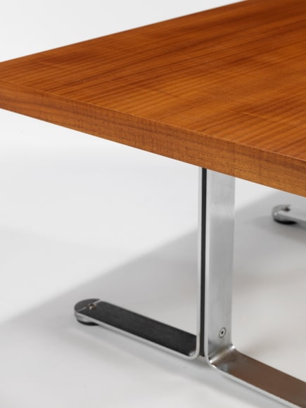 photograph in blank room with table by Tallon made with teak wood top and steel and metal legs