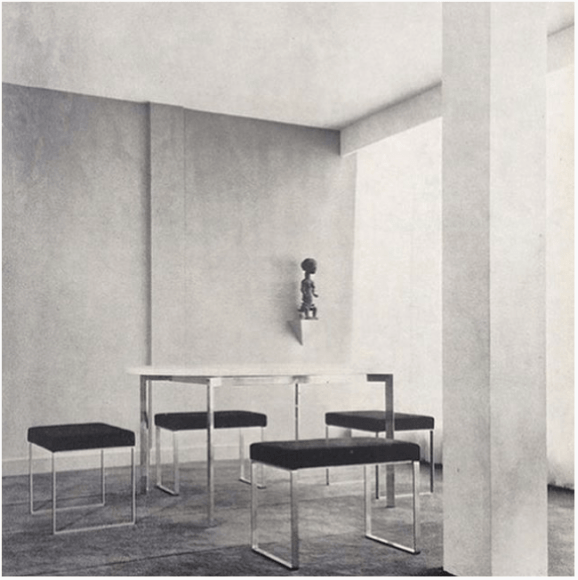 Archival image of stools and table in an apartment setting.