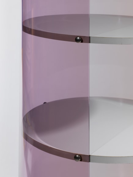 photograph of Laporte bookcase in a blank room, bookcase is rounded