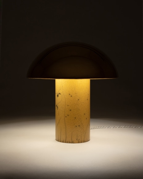 Illuminated lamp with gold glaze shade and yellow raku glazed base