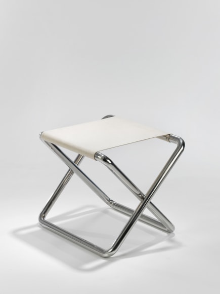 metal folding stool in an empty room