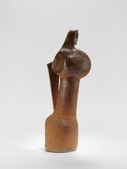 photograph of an anthropomorphic vase in an empty room