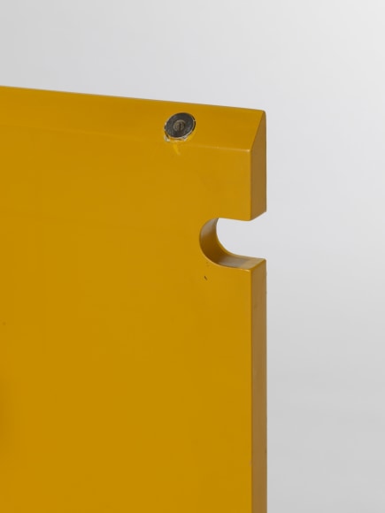 photograph of a yellow cabinet in a blank room