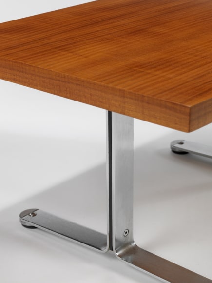 photograph in blank room with table by Tallon made with teak wood top and steel and metal legs