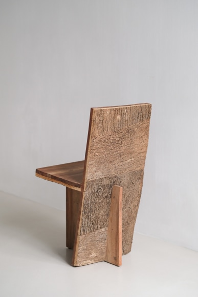 wood and cork chair with angled back shown in every angle against a grey background.