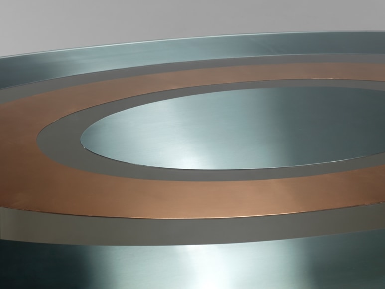 picture of a table with glass base in a gray room