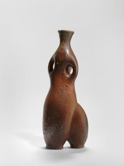 photograph of an anthropomorphic vase in an empty room