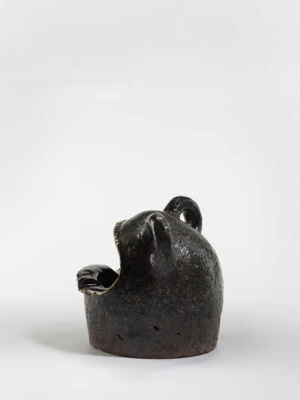photograph of a zoomorphic frog bowl in an empty room