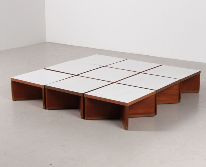 a set of 9 small white tables in a room