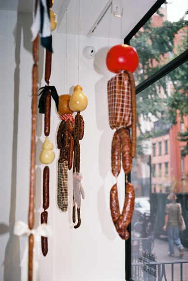 Interior view of saucissons and scamorza&nbsp;figures levitating in the window. Photo by Adrianna Glaviano&nbsp;