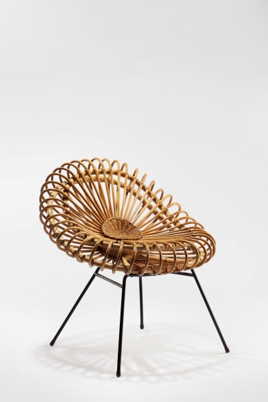 picture of rattan chair with steel legs in a blank room
