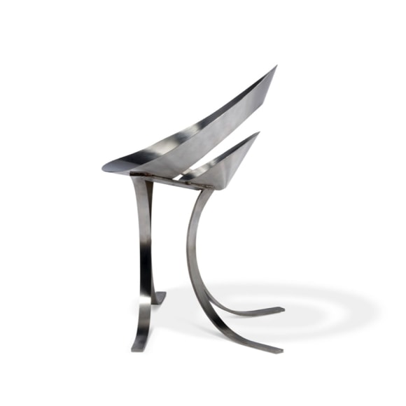 Maria pergay chair made with two rings in steel. On blank white background.