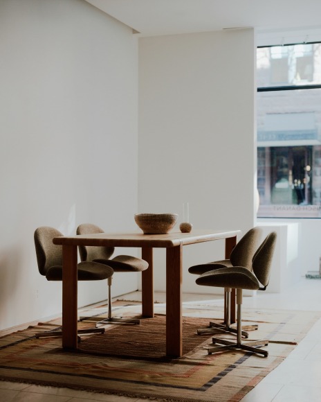 Installation view of works in the gallery, mostly furniture and some rugs and art.