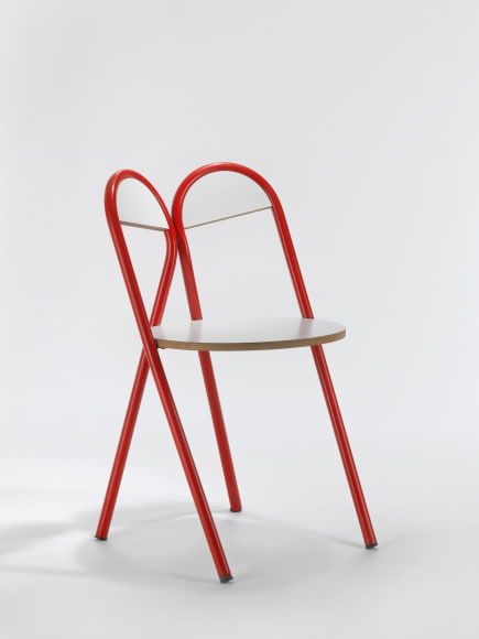 Red and white chair in front of white background