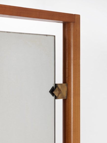 Detail of corner where brass hardware holds mirror