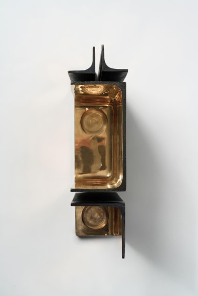 Bronze candlestick with gold detailing and black exterior.