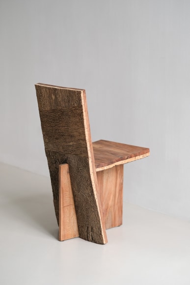wood and cork chair with angled back shown in every angle against a grey background.