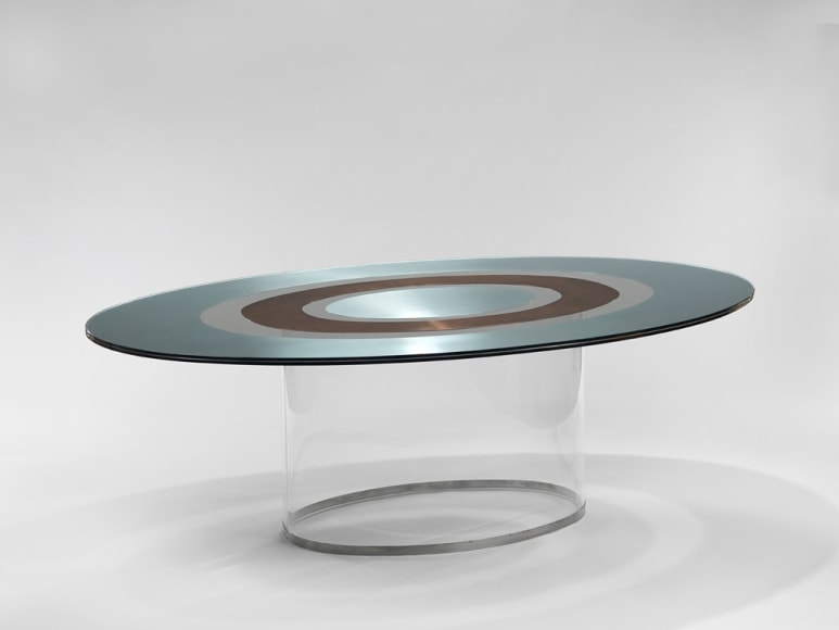 picture of a table with glass base in a gray room