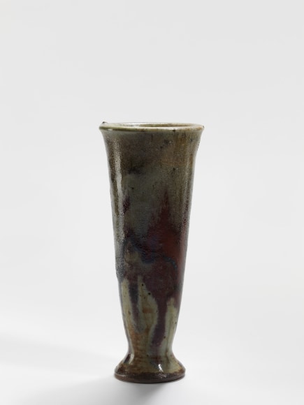 photograph of a ceramic vase in an empty room
