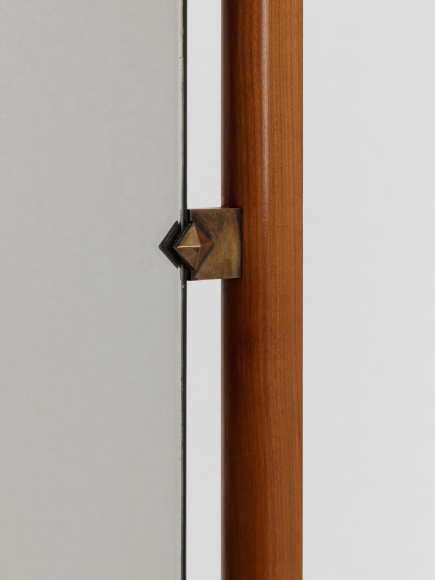 Detail of where brass hardware holds mirror
