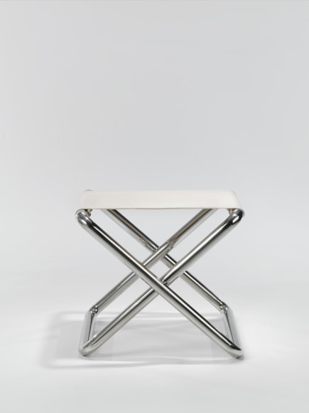 metal folding stool in an empty room