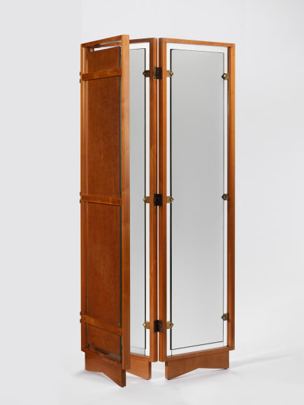 Back detail of wood framed screen with mirror panes and brass hardware