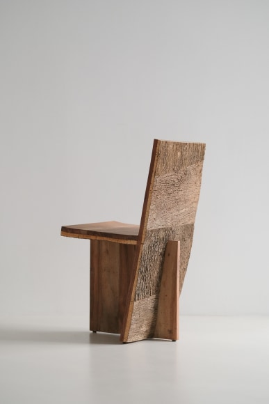 wood and cork chair with angled back shown in every angle against a grey background.