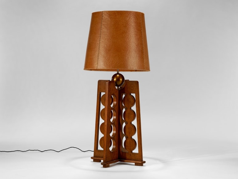 picture of a lamp with a wood base in a grey room